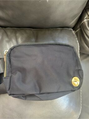 Black Women's Belt Bag with Gold Medallion Accent